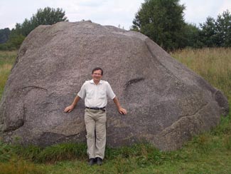 Dr. Rimantas Petrosius, University of Vilnius; geophysicist, in front of the "Devil's Stone" located in Northern vicinity of the Švendubrė village. (c) Dr. Rimantas Petrosius, 2011